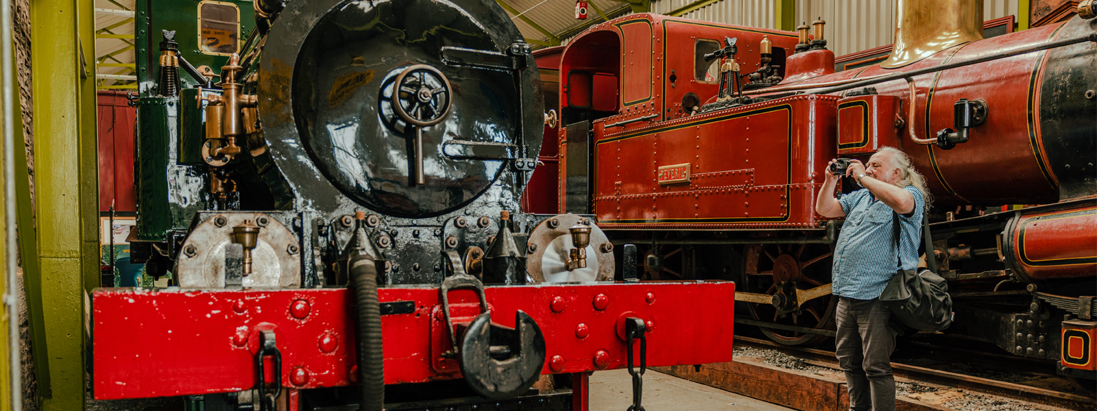 A man taking a picture of one of the old railways at the Port Erin Railway Museum on the Isle of Man